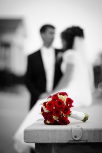 Wedding bouquet with bride and groom on the background